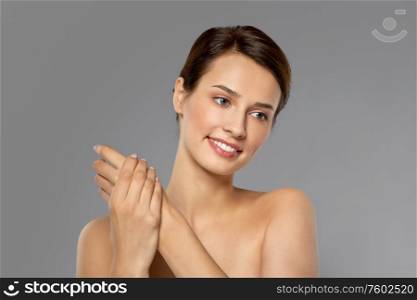 beauty, cosmetics and bodycare concept - beautiful woman applying moisturizing cream to her hand. woman applying moisturizing cream to her hand