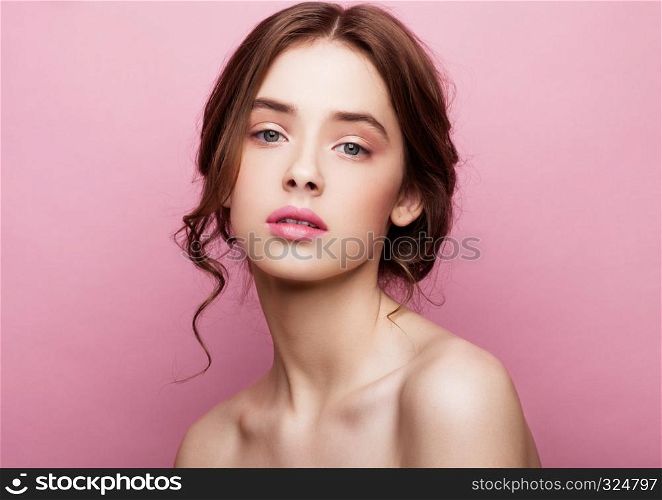 Beauty cute fashion model with natural make up on pink background