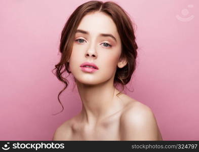 Beauty cute fashion model with natural make up on pink background