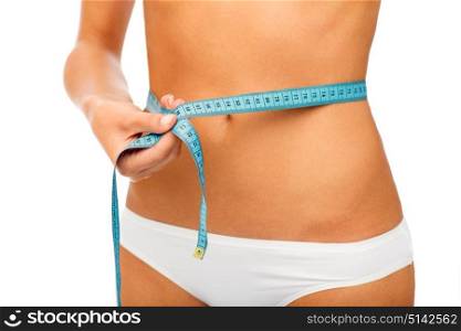 beauty, diet, slimming, weight loss and people concept - close up of woman body with measure tape around waist over white background. close up of woman body with measure tape on waist