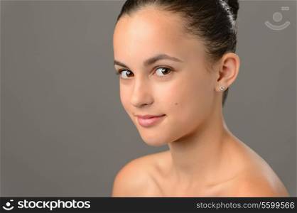 Beauty face teenage girl cosmetics skin care on gray looking camera