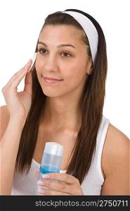 Beauty facial care - Teenager woman cleaning acne skin with cotton pad on white background