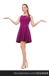 beauty, fashion, advertisement and happy people concept - young woman in purple dress and high heels holding something on palm of her hands