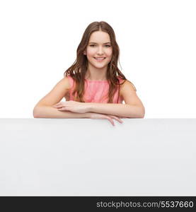 beauty, fashion, advertising and happy people concept - young woman in dress with white blank board