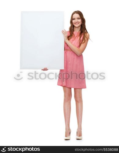 beauty, fashion, advertising and happy people concept - young woman in dress with white blank board