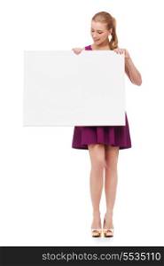 beauty, fashion, advertising and happy people concept - young woman in purple dress and high heels with white blank board