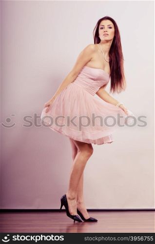 Beauty, fashion and elegant people concept - full length young brunette slim woman in bright dress and high heels shoes
