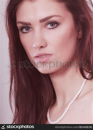 Beauty, fashion and elegant people concept - young brunette woman long hair girl wearing pearls necklace