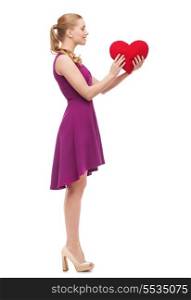 beauty, fashion, love and happy people concept - young woman in purple dress and high heels and red heart