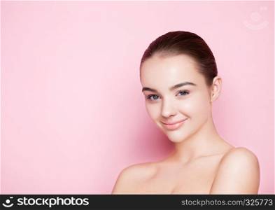 Beauty fashion model girl natural makeup with cute smile on pink background