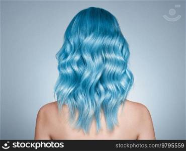 Beauty fashion model girl with blue dyed hair. Girl with curly hair. Model with perfect healthy dyed hair