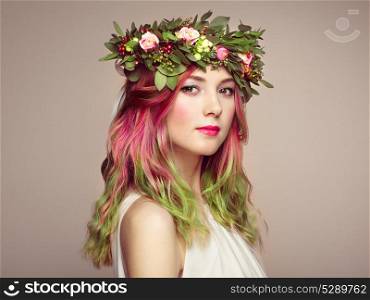 Beauty fashion model girl with colorful dyed hair. Girl with perfect makeup and hairstyle. Model with perfect healthy dyed hair. Flower wreath on head