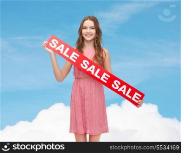 beauty, fashion, shopping and happy people concept - young woman in dress with sale sign