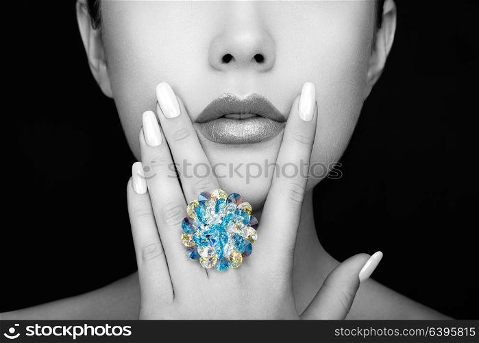 Beauty Fashion Woman lips with natural Makeup and white Nail polish. Gloss Lipstick. Beauty girl face close up. Sexy Lips, Manicure, Make up. Ring with Precious Stones, Jewelry
