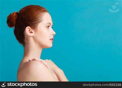Beauty female body. Attractive sensual woman red hair with nacked shoulders. Pertect clean soft skin. Young woman with naked shoulders