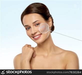 beauty, future technology and people concept - beautiful young woman with pointer on her zoomed face skin with low poly shape projection over blue background. young woman with face skin in zoomed pointers