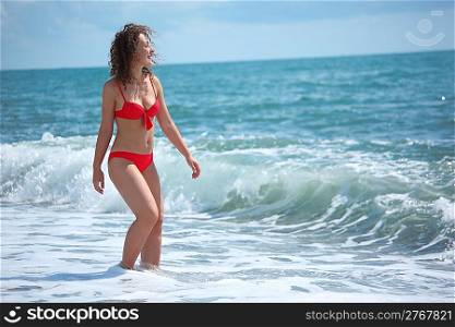 beauty girl stands in sea surf