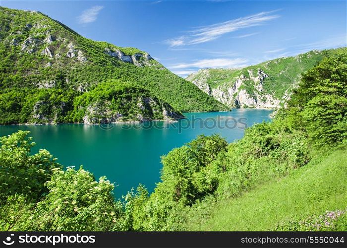 Beauty green mountains and lake with dramatic sky