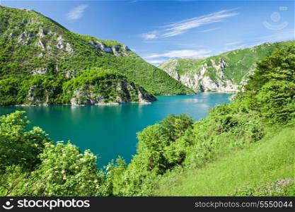 Beauty green mountains and lake with dramatic sky
