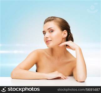 beauty, health and people concept - smiling beautiful woman with clean perfect skin over blue laser lights background