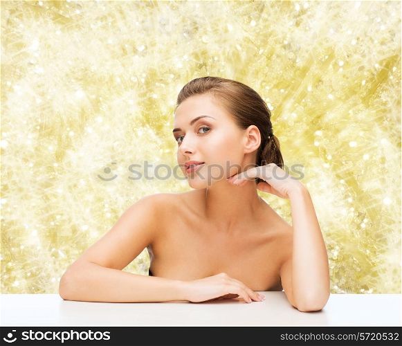 beauty, health and people concept - smiling beautiful woman with clean perfect skin over yellow lights background