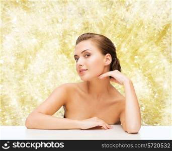 beauty, health and people concept - smiling beautiful woman with clean perfect skin over yellow lights background