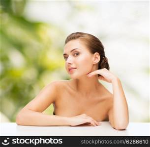 beauty, health and people concept - smiling beautiful woman with clean perfect skin over green background