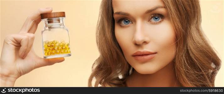 beauty, health care, medicine and pharmaceutics concept - bright picture of beautiful woman with omega 3 vitamins