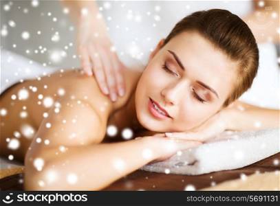 beauty, health, holidays, people and spa concept - beautiful young woman in spa salon getting massage