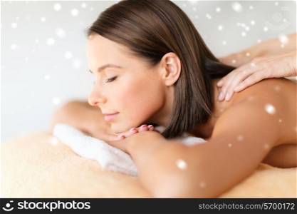 beauty, health, holidays, people and spa concept - beautiful young woman in spa salon getting massage