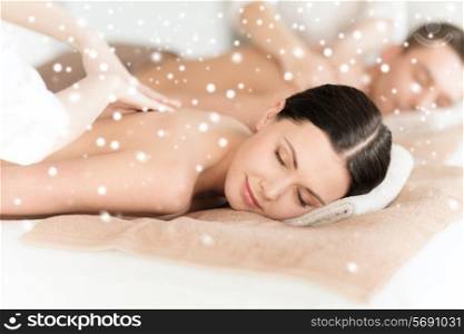 beauty, health, holidays, people and spa concept - happy couple with closed eyes lying getting back massage in spa salon