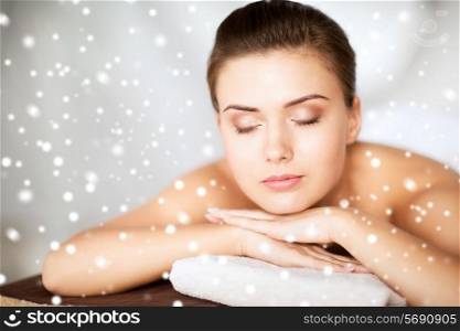 beauty, health, people and spa concept - beautiful young woman in spa