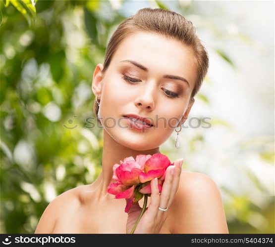 beauty, holidays and jewelry - woman with diamond earrings, ring and flower