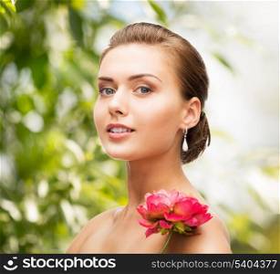 beauty, holidays and jewelry - woman with diamond earrings, ring and flower