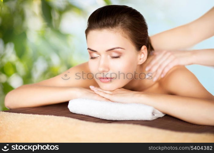 beauty, holidays and spa concept - woman in spa salon getting massage