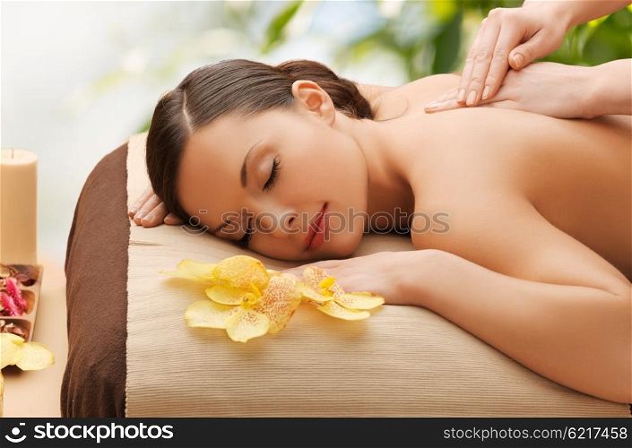 beauty, holidays and spa concept - woman in spa salon getting massage