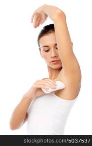 beauty, hygiene, bodycare and people concept - beautiful young woman applying antiperspirant or stick deodorant over white background. woman with antiperspirant deodorant over white