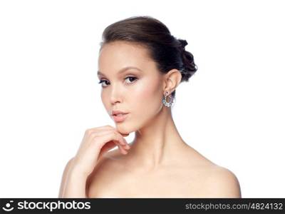 beauty, jewelry, accessories, people and luxury concept - close up of beautiful asian woman face with earring