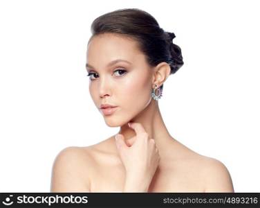 beauty, jewelry, accessories, people and luxury concept - close up of beautiful asian woman face with earring