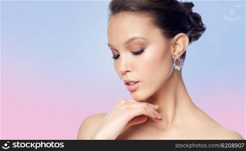 beauty, jewelry, accessories, people and luxury concept - close up of beautiful asian woman face with earring over rose quartz and serenity gradient background