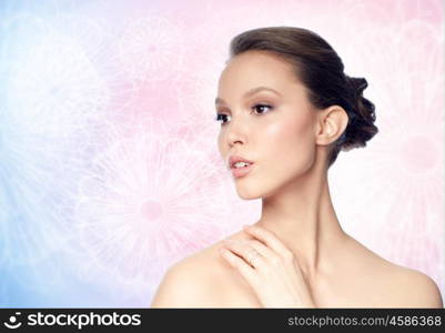 beauty, jewelry, accessories, people and luxury concept - face of beautiful young asian woman with golden ring over rose quartz and serenity pattern background