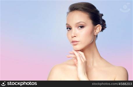 beauty, jewelry, accessories, people and luxury concept - face of beautiful young asian woman with golden ring over rose quartz and serenity gradient background