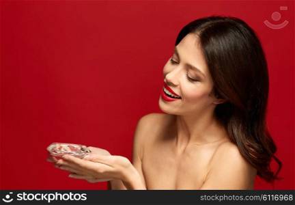 beauty, jewelry and people concept - happy smiling young woman with red lipstick holding big diamond. beautiful woman with red lipstick holding diamond. beautiful woman with red lipstick holding diamond