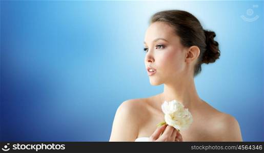 beauty, jewelry, people and luxury concept - beautiful asian woman or bride in white dress with peony flower and golden ring over blue background