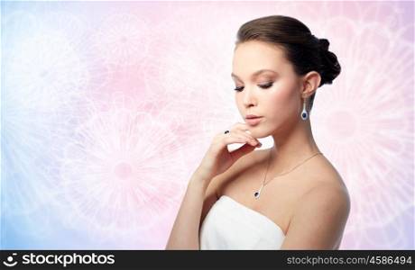 beauty, jewelry, people and luxury concept - beautiful asian woman or bride with earring, finger ring and pendant over rose quartz and serenity patterned background