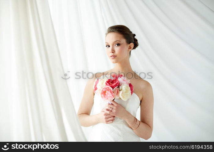 beauty, jewelry, people and luxury concept - beautiful asian woman or bride in white dress with peony flower, golden ring and bracelet