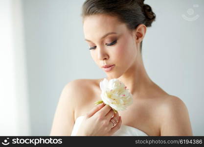 beauty, jewelry, people and luxury concept - beautiful asian woman or bride in white dress with peony flower, golden ring and bracelet
