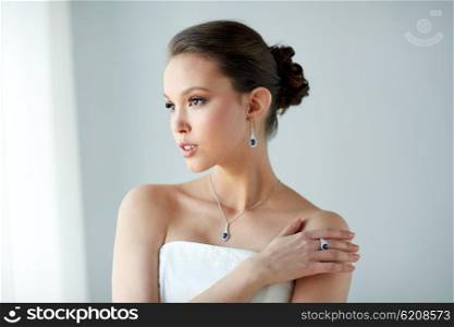 beauty, jewelry, people and luxury concept - beautiful asian woman or bride with earring, finger ring and pendant