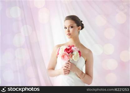 beauty, jewelry, people and luxury concept - beautiful asian woman or bride in white dress with peony flower, golden ring and bracelet over holidays lights background