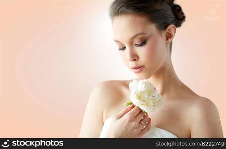beauty, jewelry, people and luxury concept - beautiful asian woman or bride in white dress with peony flower and golden ring over beige background